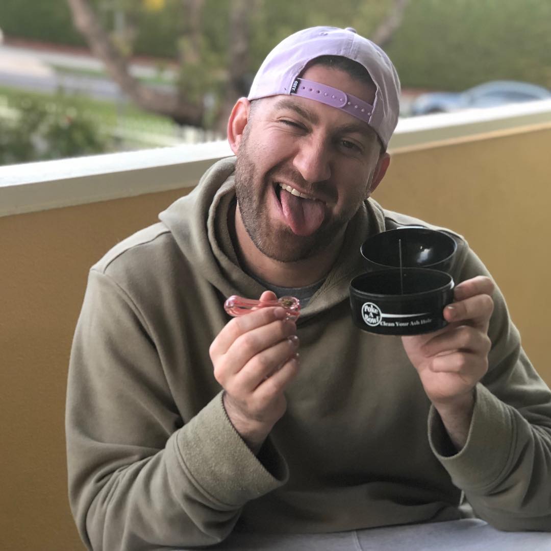 Happy customer using Poke A Bowl ashtray with glass pipe and debowler tool